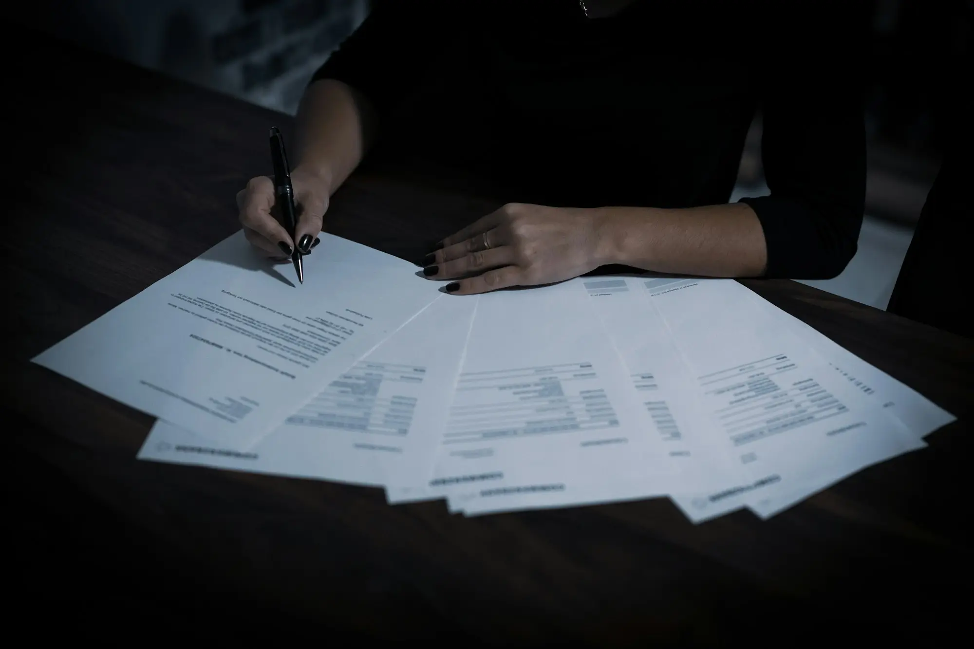 Director reading through refinance documents before signing