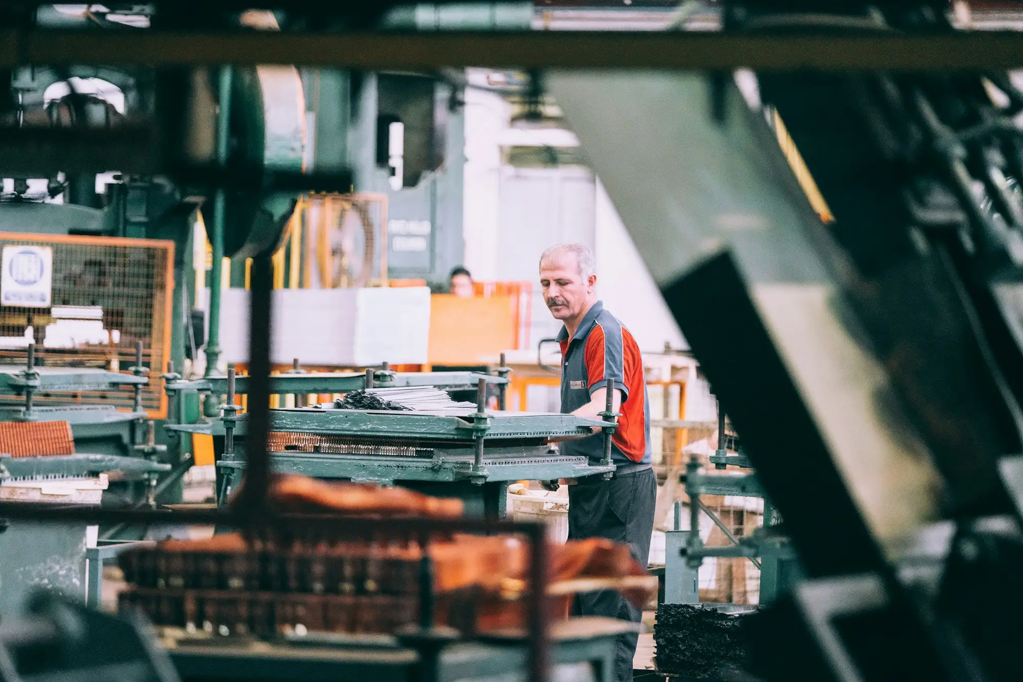 Operator working machinery on a manufacturing plant floor