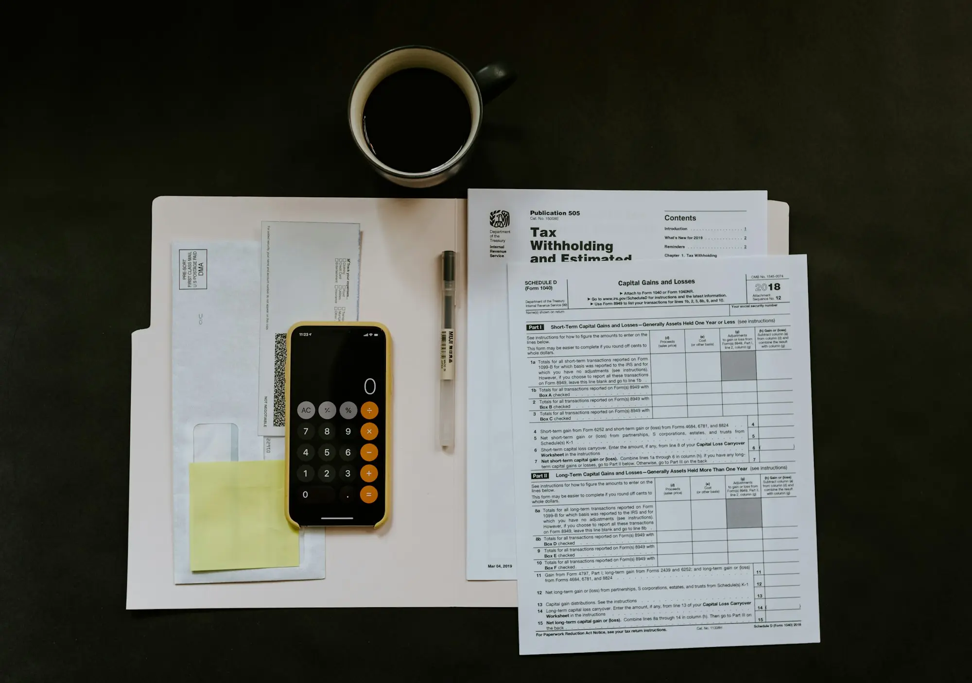 Printed financial reports, calculator and coffee on a desk