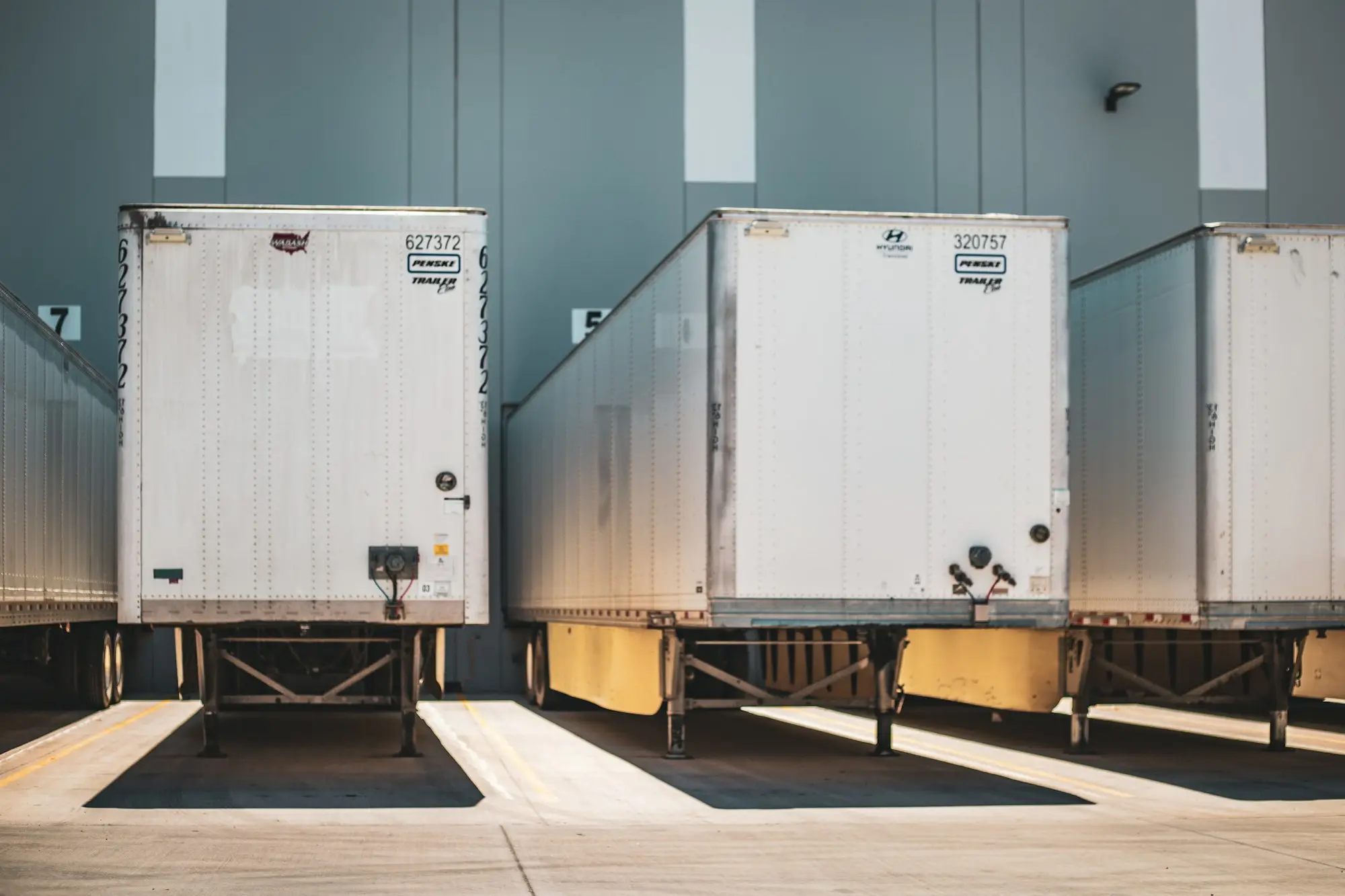 Truck trailers backed up to a warehouse loading dock