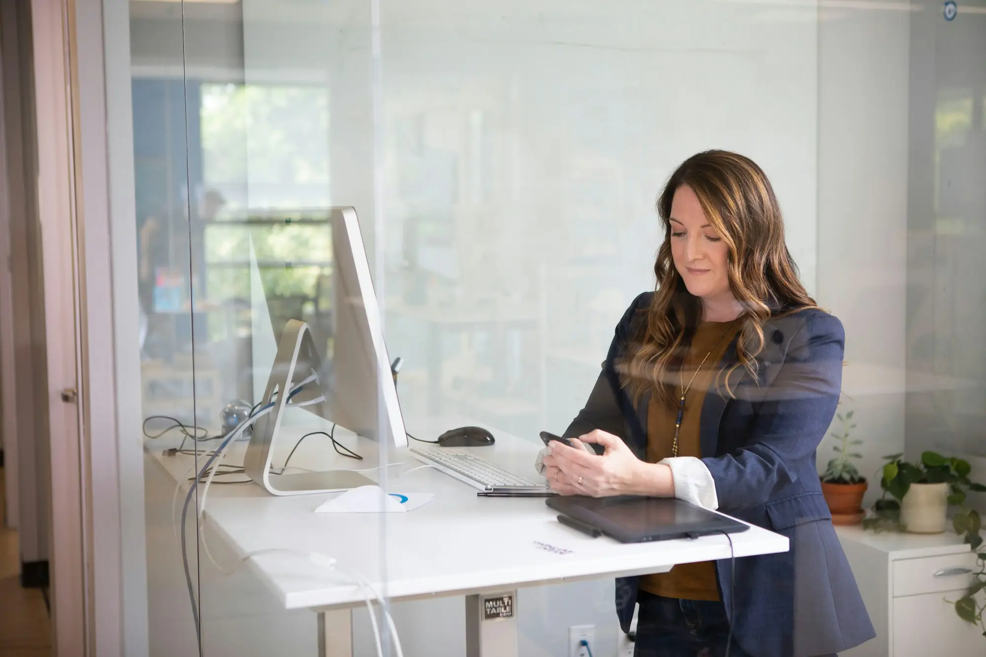 Professional writing notes for a funding proposal beside a laptop